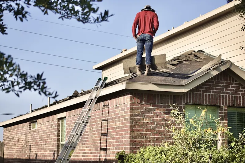 Professional roofer working on a residential roof in Dogwood Village